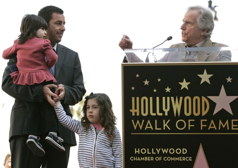 Image: Sandler and his daughters, Sunny and Sadie, listen as Winkler speaks during a ceremony honoring Sandler with a star on the Hollywood Walk of Fame in Hollywood