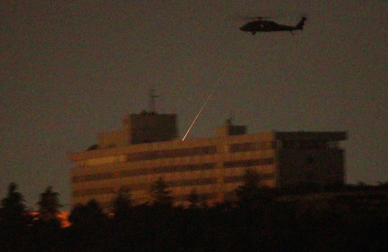 Image: A NATO helicopter fires a missile on the roof of the Intercontinental hotel in Kabul