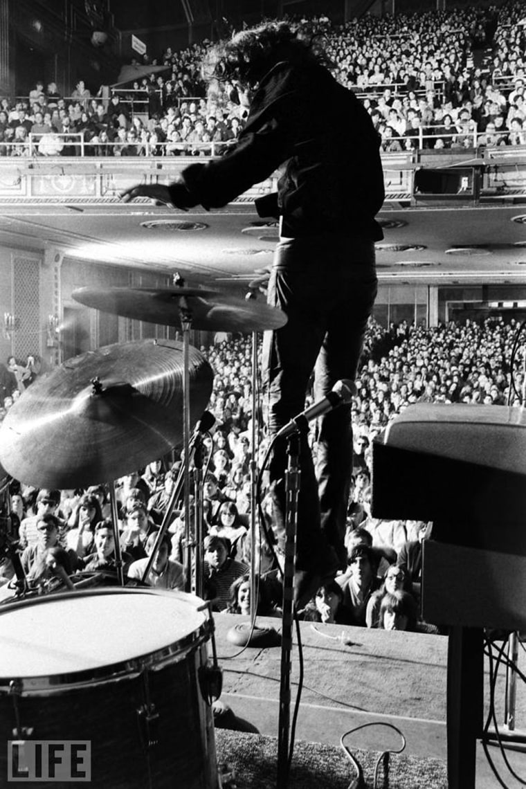 Image: Jim Morrison leaps onstage during a Doors concert at New York's Fillmore East