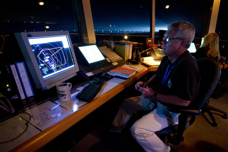 Image: NASA Air Traffic Controller Parker monitors air traffic from control tower moments before Endeavour makes its final landing at Kennedy Space Center in Cape Canaveral