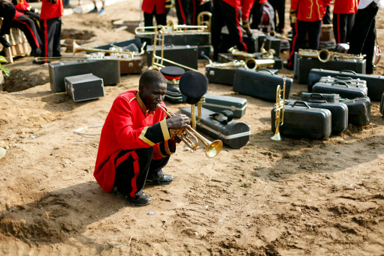 Image: A musician practises before the start of a rehearsal of the Independence Day ceremony in Juba