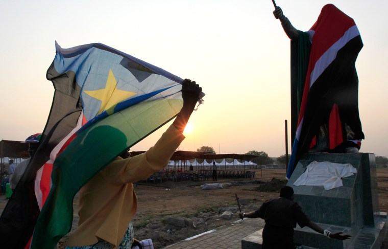 Image: A woman carries a South Sudan flag as she arrives at the John Garang Mouselium for the Independence Day celebrations in the capital Juba