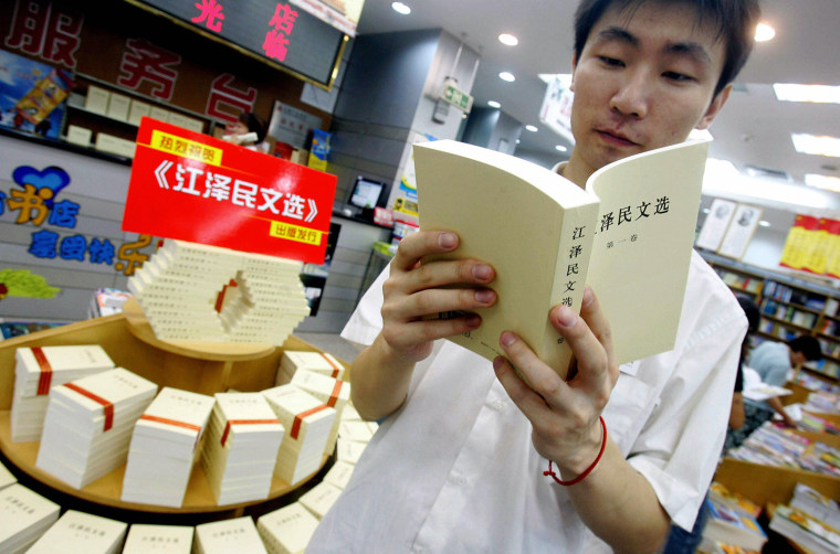 A customer reads a book by former Chines