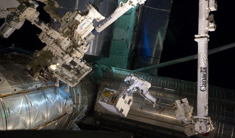 Image: Astronaut Mike Fossum works outside the International Space Station during his spacewalk.