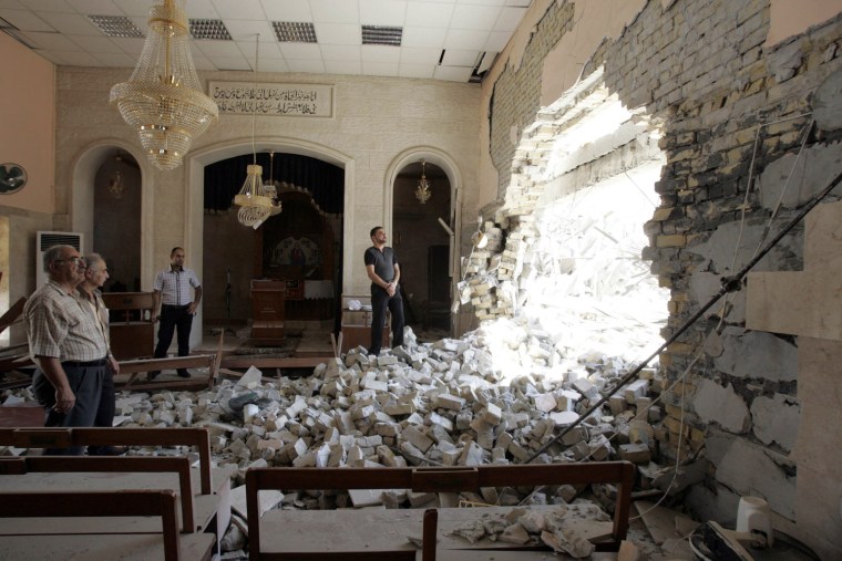 Image: Residents inspect a damaged church after a bomb attack in central Kirkuk