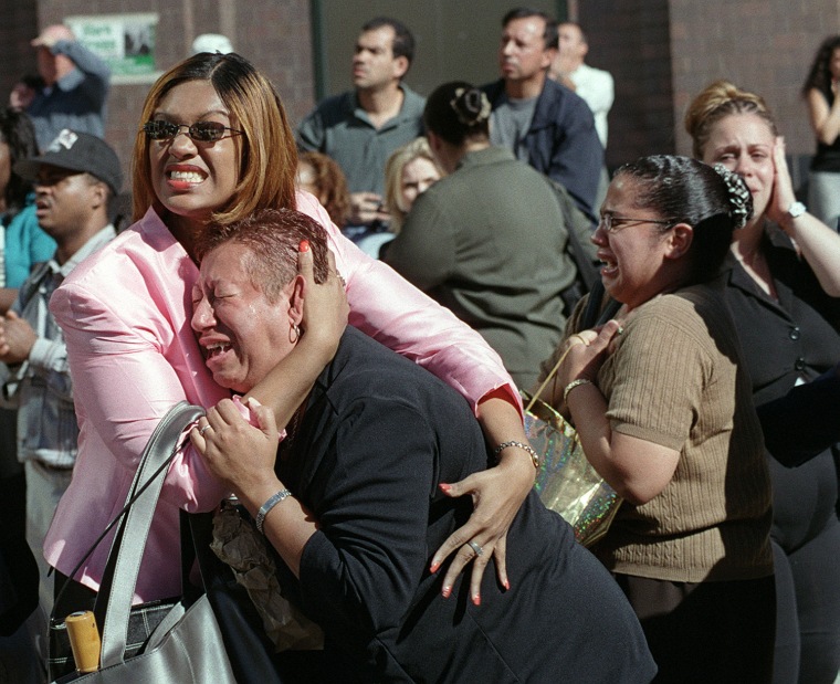 TYwo women hold each other as they watch the World Trade Center burn following a terrorist attack on the twin skyscrapers in New York Tuesday, Sept. 11, 2001.  Terrorists crashed two planes into the World Trade Center and the twin 110-story towers collapsed Tuesday morning. (AP Photo/Ernesto Mora)