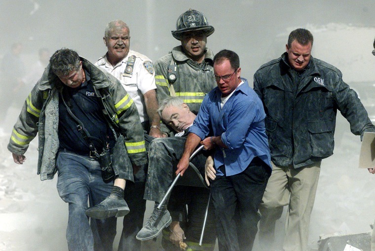 RESCUE WORKER REMOVE A MAN AFTER WORLD TRADE CENTER HIT BY PLANE