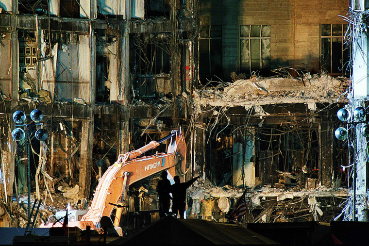 Rescue workers work late 18 September 2001 Washington, DC, sifting through piles of debris from the section of the Pentagon hit by the terrorist attack 11 September.  US President George W. Bush vowed to \"rally the world\" behind his campaign to eradicate global terrorism and won French President Jacques Chirac's pledge to back that effort \"unreservedly.\"   (FILM)   AFP PHOTO/Manny CENETA
