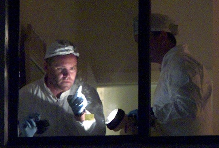 FBI CRIME LAB INVESTIGATOR POINTS TO FINGER PRINT ON WINDOW AT TERRORIST SUSPECTS CONDOMINIUM