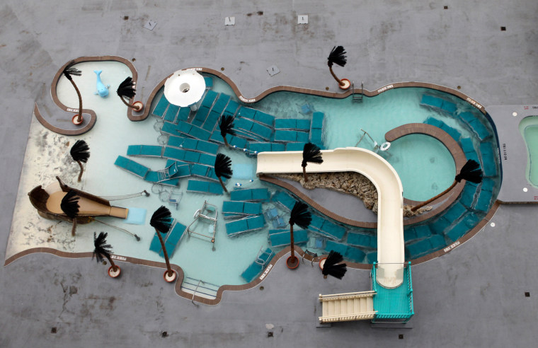 Image: Pool lounge chairs are stored in the pool during Hurricane Irene in Ocean City