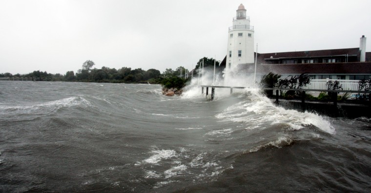 Image: A lighthouse-shaped building is battered by storm surge and winds from Hurricane Irene in Montauk, New York