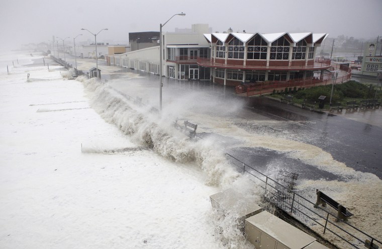 Image: Waves and storm surge pound the boardwalk and the beach at first light as Hurricane Irene slams into Asbury Park