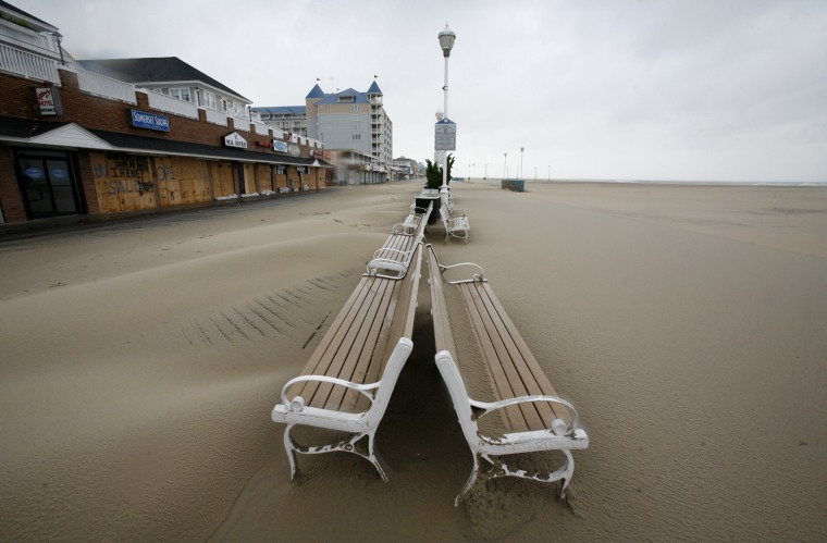 Image: Sand covers the board walk after Hurricane Irene passed through in Ocean City
