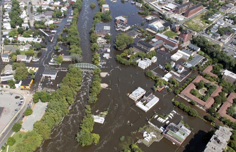Image: Flood waters from the Passaic River overrun the banks, filling the streets of Paterson