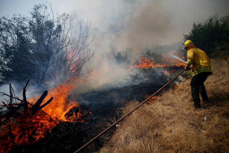 Image: Lone Camp Volunteer Fire Department fire fighter Joe Crawford fights a wildfire