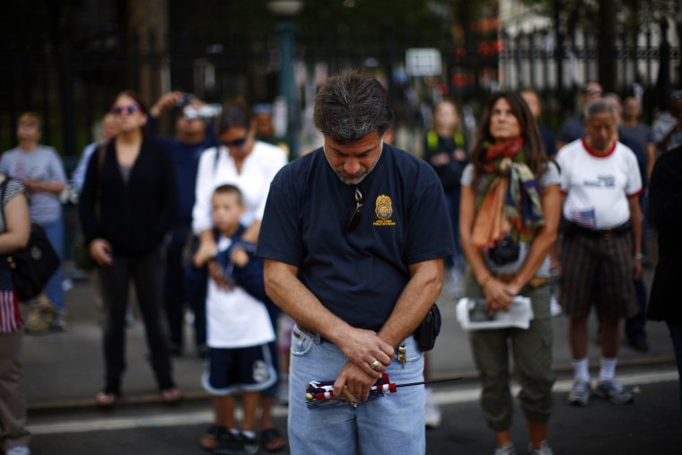 Image: People react during ceremonies marking the 10th anniversary of the 9/11 attacks