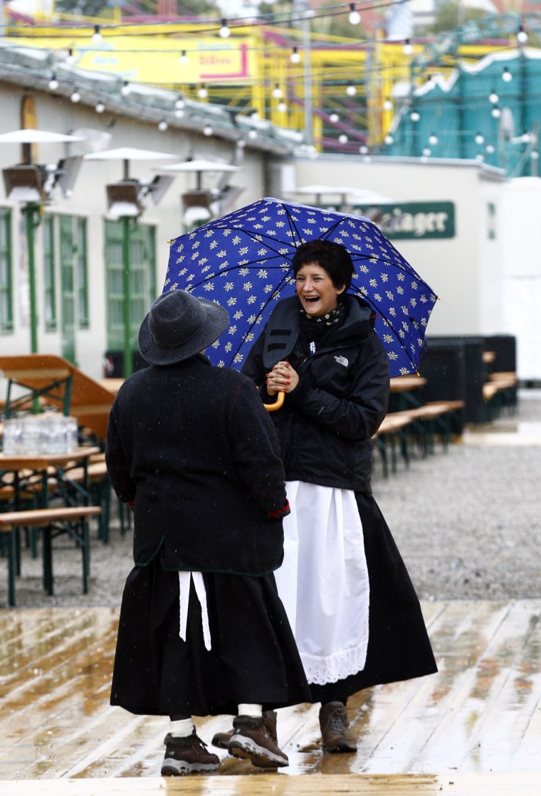Image: Oktoberfest waitresses wait for customers during a rainy day in Munich