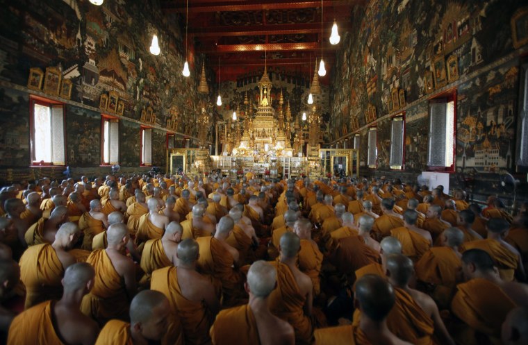 Image: Buddhist monks pray during a religious ceremony held to mark King Adulyadej's 84th birthday anniversary at the Wat Phra Kaew Temple of the Emerald Buddha in Bangkok