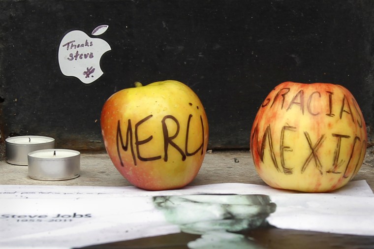 Image: Two apples are placed at the entrance the Apple store in Paris