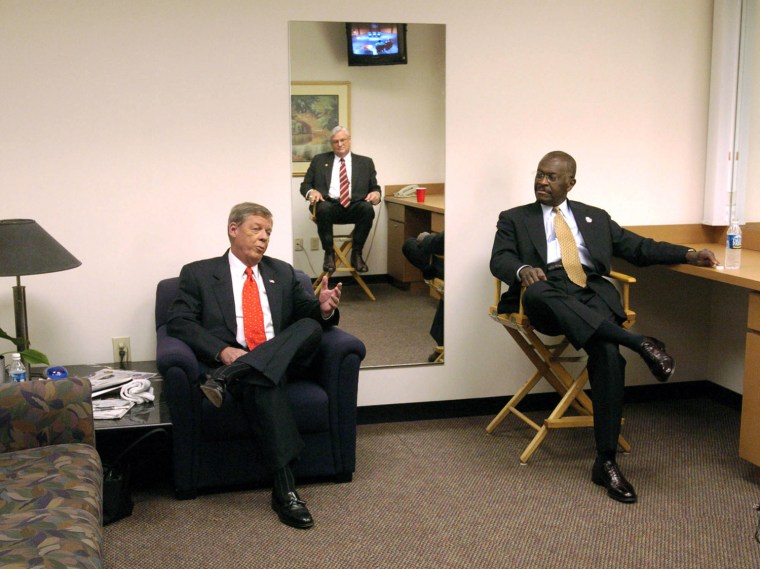 Republican candidates for Georgia's U.S. Senate seat presently held by Zell Miller, Johnny Isakson of Marietta, left, Herman Cain of Forest Park, right, and Mac Collins of Atlanta, reflected in the mirror on the wall, talk as they wait in the green room of WSB TV studios before the start of a debate between the three in Atlanta, Sunday, July 10, 2004.  (AP Photo/John Amis)
