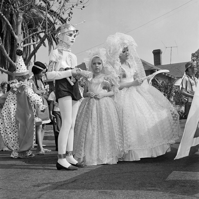 Pictured here is the Halloween festival in Anaheim, Calif., Oct. 20, 1962. Nearly everyone  turns out to watch the parade, and thousands are on hand to watch the show that launches it at the Palma Stadium. Another 7,000 or more school children take part in a youngsters' parade and there is breakfast for 2,000 costumed citizens.  (AP Photo)