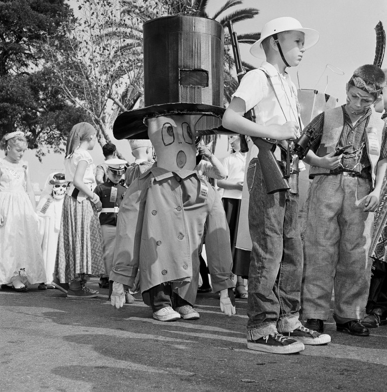 Pictured here are children preparing for the Halloween festival in Anaheim, Calif., Oct. 20, 1962. Nearly everyone  turns out to watch the parade, and thousands are on hand to watch the show that launches it at the Palma Stadium. Another 7,000 or more school children take part in a youngsters' parade and there is breakfast for 2,000 costumed citizens.  (AP Photo)