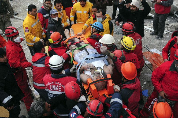 Image: Rescue workers carry earthquake survivor Mehmet Zengin to an ambulance after he was found in a collapsed building in Van, eastern Turkey