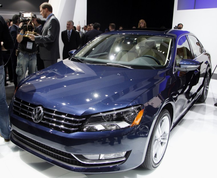 Image: Frank Fisher, CEO of Chattanooga Operations, Volkswagen Group of America, Inc. holds the 2012 Motor Trend Car of the Year award for the 2012 Volkswagen Passat as he is interviewed beside the car at the LA Auto Show in Los Angeles