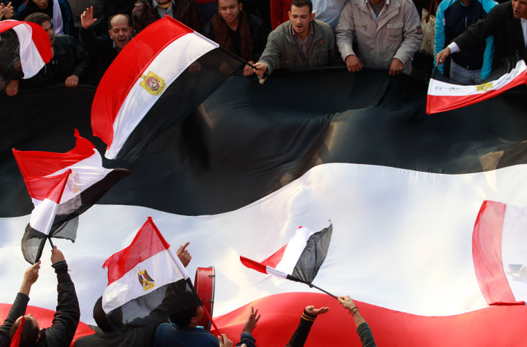 Image: Supporters of Egyptian Armed Forces shout slogans and wave Egyptian national flags on road near defence ministry at Abbasiya square in Cairo