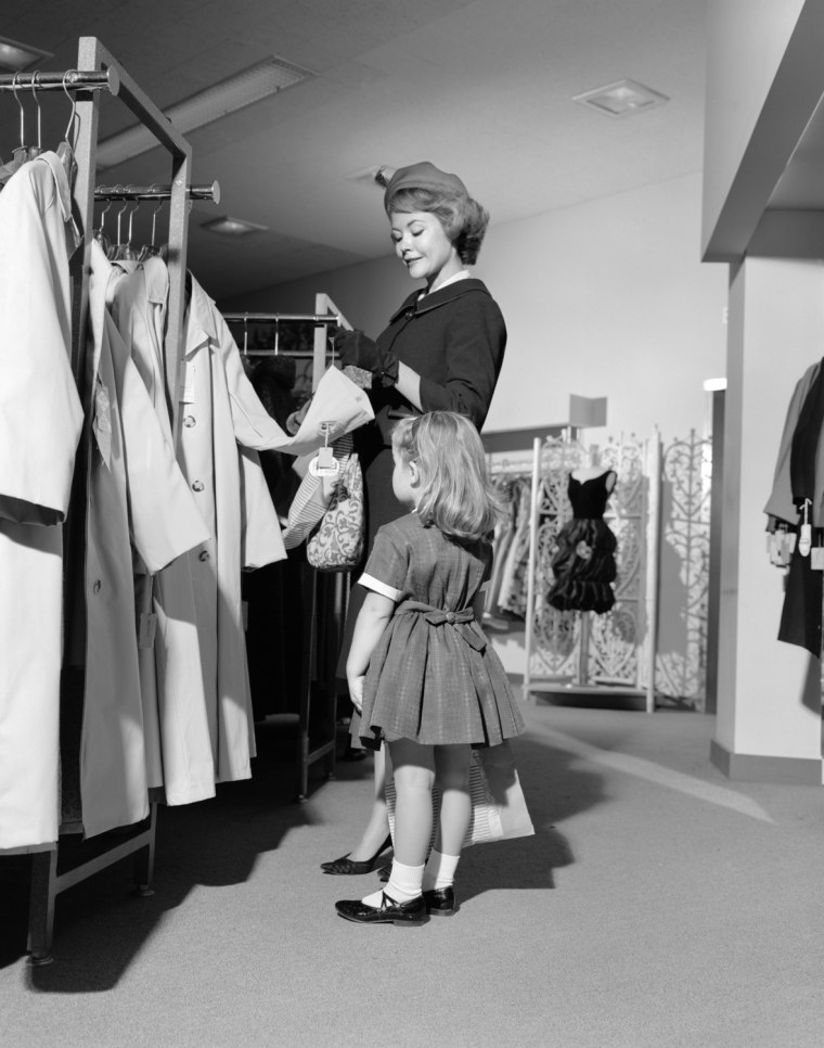 1960s MOTHER AND DAUGHTER SHOPPING FOR CLOTHES IN AISLE OF DEPARTMENT STORE. H. ARMSTRONG ROBERTS/CLASSICSTOCK/Everett Collection (s12468)