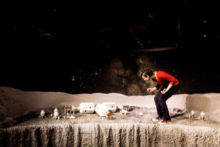 Image: Hillary Livingston adds finishing touches on a lunar base camp model.