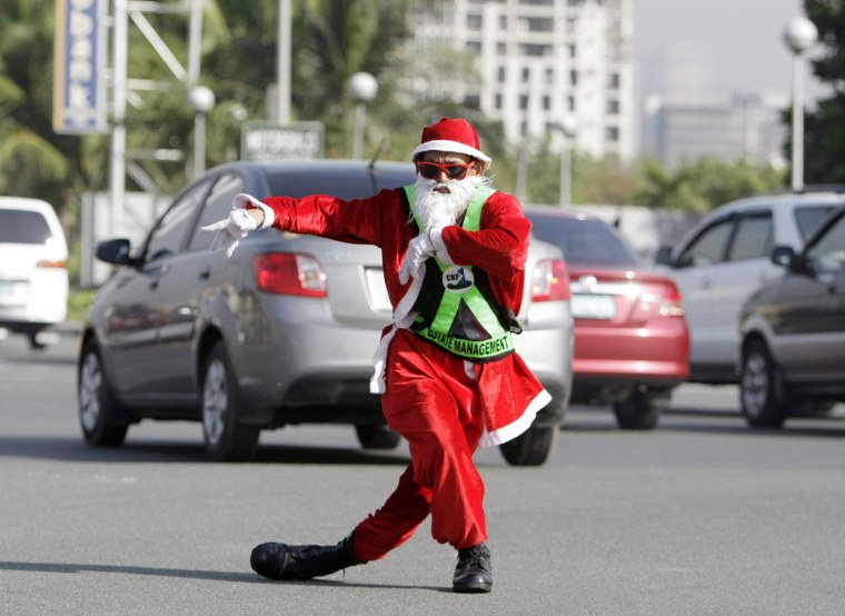 Image: Traffic enforcer in santa Claus at a street in Manila.