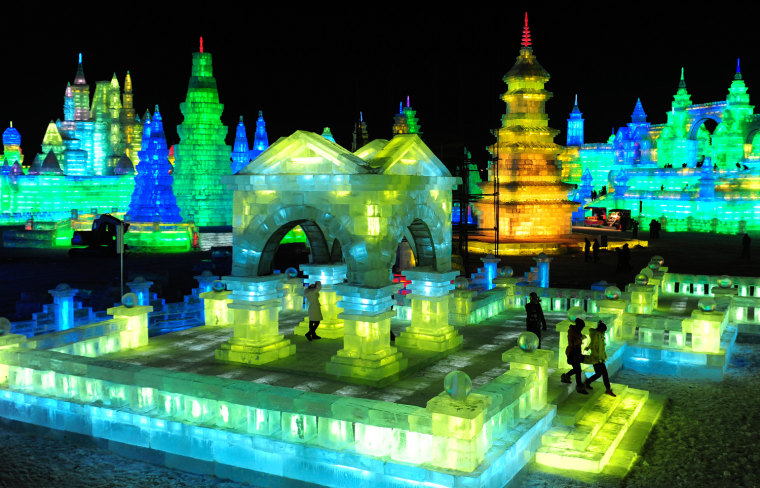Image: Tourists visit ice sculptures during tthe lights testing period of the 13th Harbin Ice and Snow World in Harbin