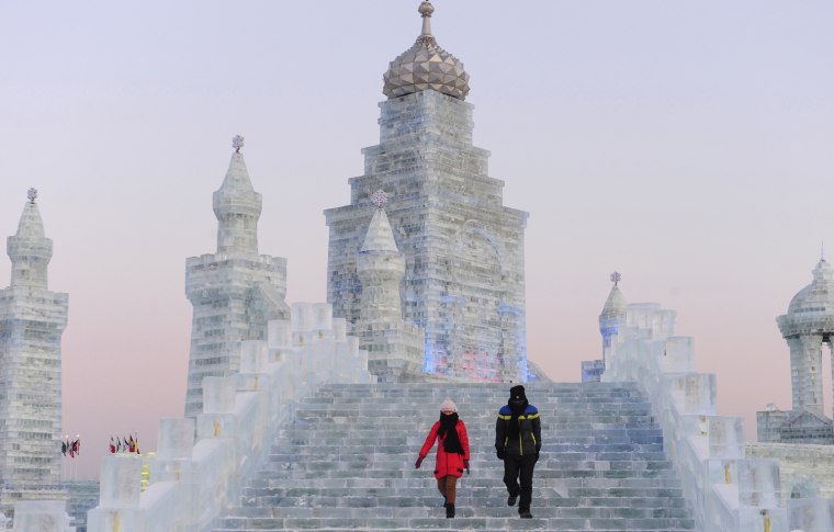Image: Tourists visit ice sculptures during the testing period of the 13th Harbin Ice and Snow World in Harbin
