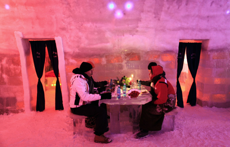 Image: Tourists have dinner inside the Balea Lac Hotel of Ice in the Fagaras mountains