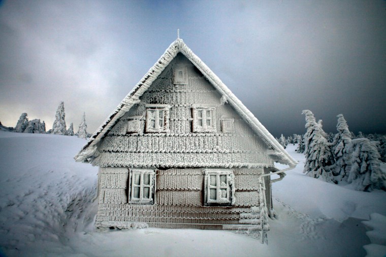 Image: A frozen house is seen on a track of the Sedivackuv Long dog sled race in Destne v Orlickych horach