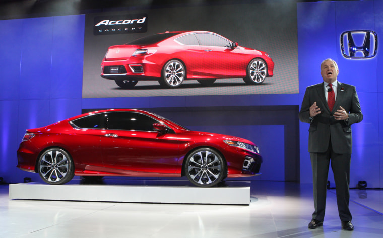 Image: Honda's Mendel speaks next to Accord plug in hybrid concept car as it is displayed on the final press preview day for the North American International Auto Show in Detroit