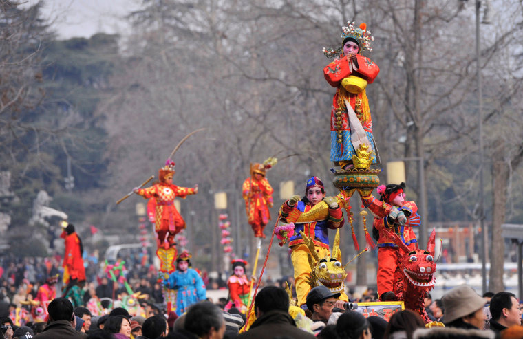 Image: Performers take part in a performance called \"Tai Ge\" during the second day of the Chinese Lunar New Year at a park in Nanjing