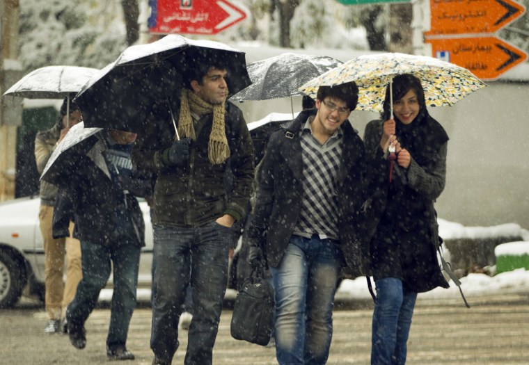 Image: University students cross a street during a snow storm in Tehran