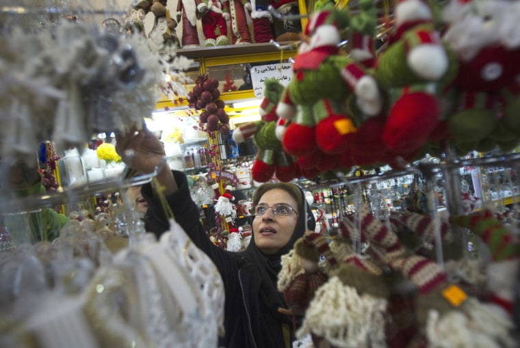Image: Iranian-Christian woman looks at Christmas decorations while shopping in central Tehran
