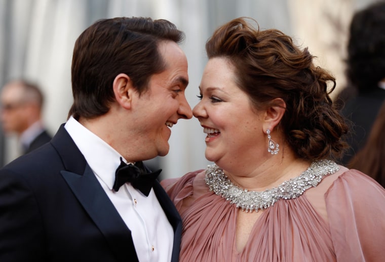 Image: Actress Melissa McCarthy and her husband Ben Falcone arrive at the 84th Academy Awards in Hollywood