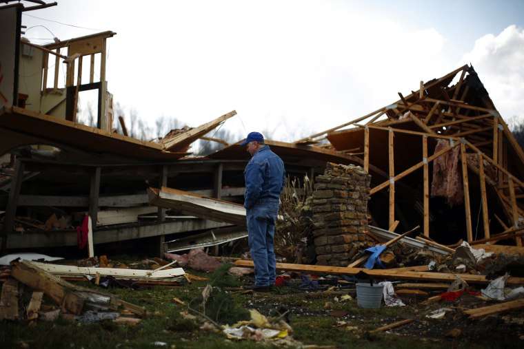 Image: Philip Whitley stands in front of a damaged church after tornadoes swept through Salyersville