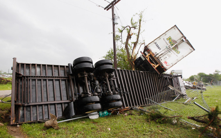 Image: Semi-tractor trailers lay in debris left by a tornado which passed through the southern area of Dallas, Texas