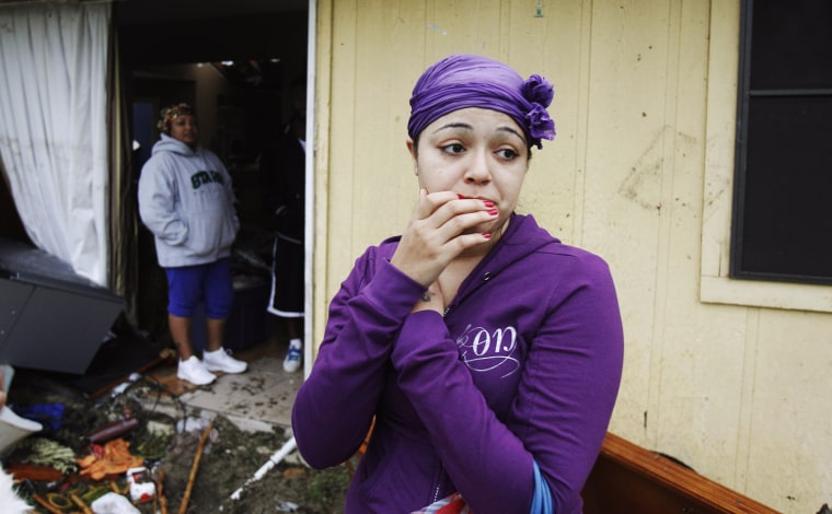 Image: A resident looks at the damage caused by a tornado that ripped through the Dallas suburb of Lancaster