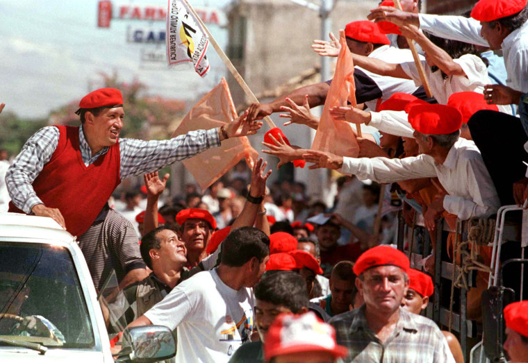 Image: Former paratrooper and leading presidential candidate Hugo Chavez reaches out to supporters in Caror..