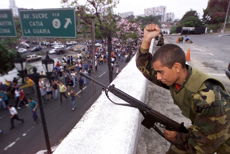 Image: SOLDIER CHEERS TO SUPPORTERS OF CHAVEZ IN CARACAS.
