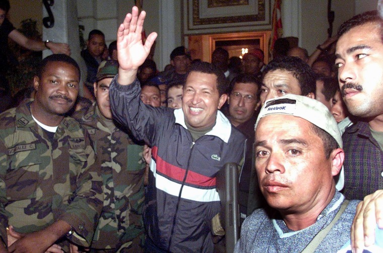 Image: Venezuelan President Hugo Chavez is surr