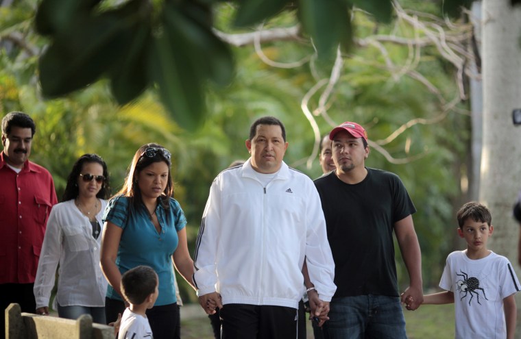 Image: Venezuelan president Chavez walks with his family while recovering in La Habana