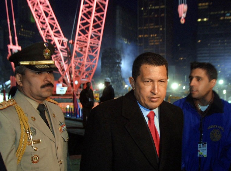 Image: Venezuelan President Hugo Chavez (C) tours Ground