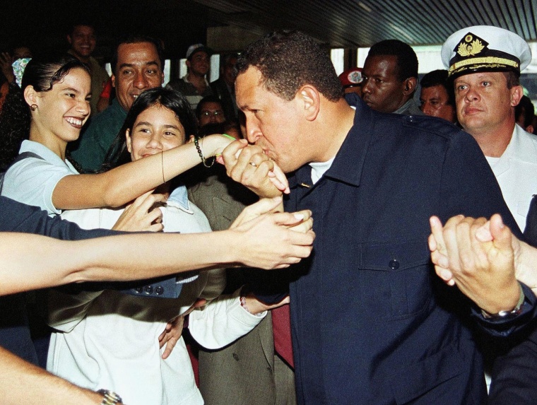 Image: Venezuelan President Hugo Chavez Frias kisses the